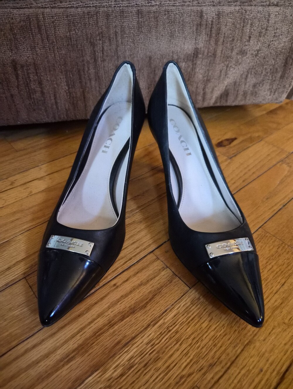 Coach Black Pointed Leather Pumps with Silver Logo Plate
